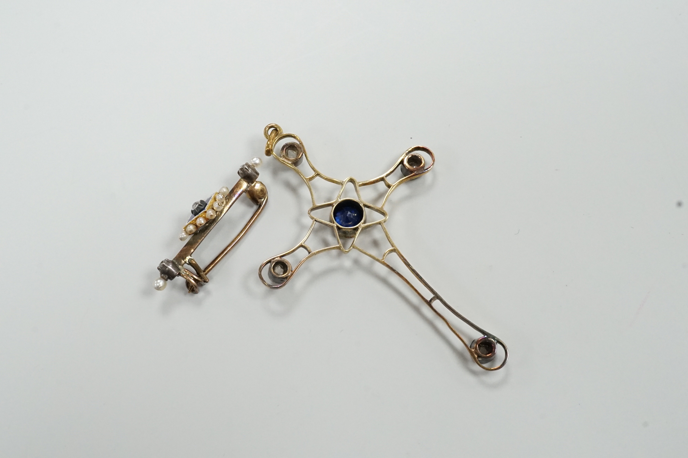 An Edwardian yellow metal, enamel and diamond chip set brooch, 30mm and a rose cut diamond and synthetic sapphire? set yellow metal cross pendant, gross weight 6.8 grams.